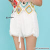 Woman wearing beige chiffon summer shorts with tassel tie and pom pom hem