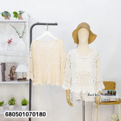 Boho-inspired cotton blouse with crochet texture and relaxed shape on mannequin