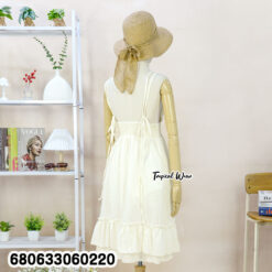 sleeveless white and cream cotton sundresses displayed with ruffle hem