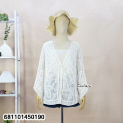 Mannequin wearing cream and white wholesale bohemian lace cardigan with straw hat in a Bangkok showroom.