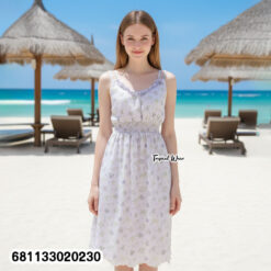 Floral pastel midi dress with elastic waist worn at beach setting, lightweight summer resort style.