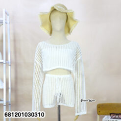 Woman wearing knit beach co-ord set with long sleeve top and pants, lightweight summer layering outfit.