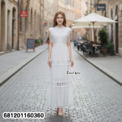 Elegant white lace maxi dress with sleeveless design and waist tie, styled for summer resort fashion.