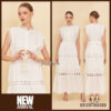 Elegant white lace maxi dress with sleeveless design and waist tie, styled for summer resort fashion.