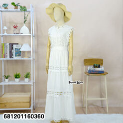 Elegant white lace maxi dress with sleeveless design and waist tie, styled for summer resort fashion.