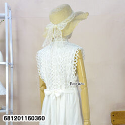 Elegant white lace maxi dress with sleeveless design and waist tie, styled for summer resort fashion.