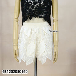 White nylon lace beach shorts styled for tropical resort look